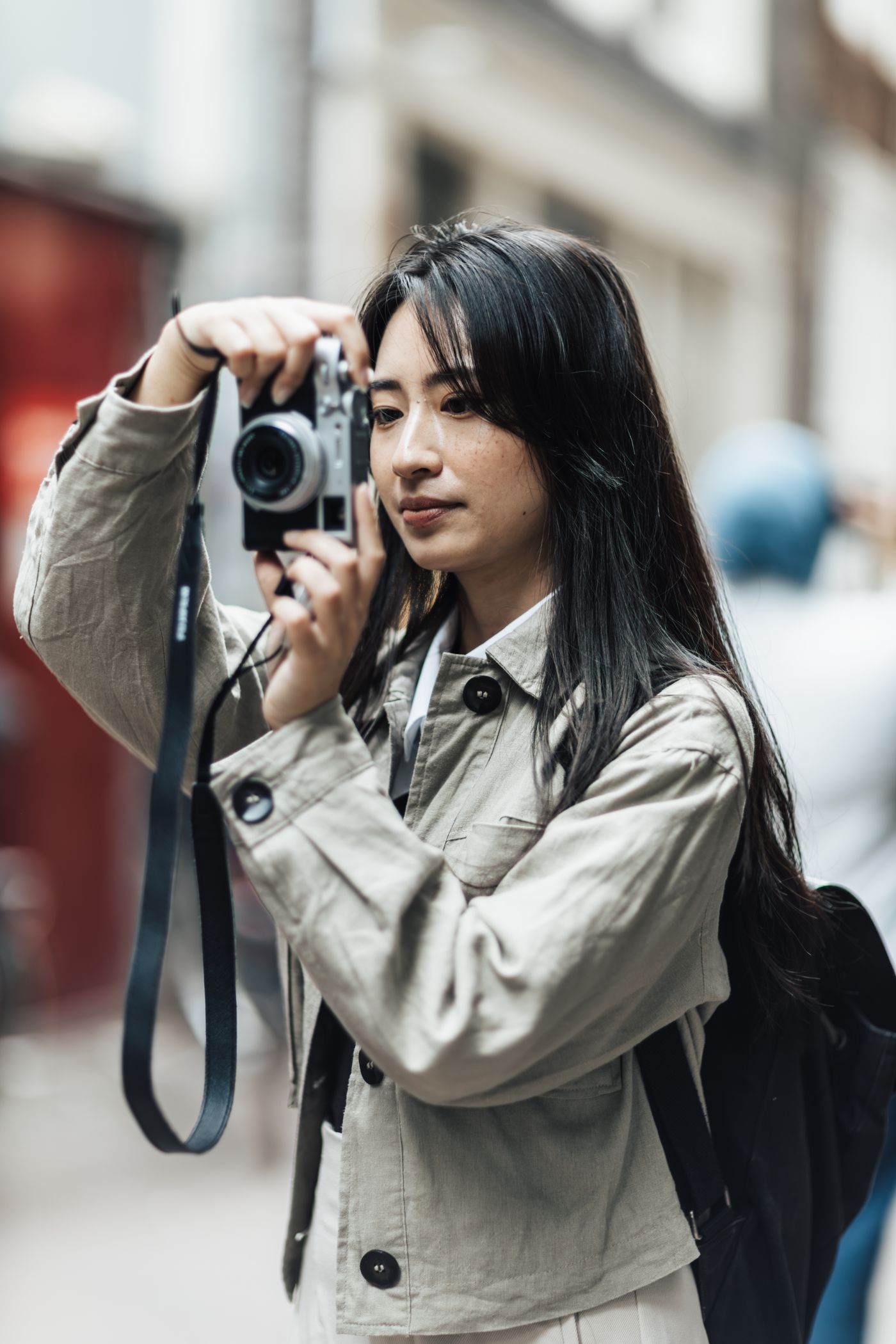 A traveler photographing an urban scene.