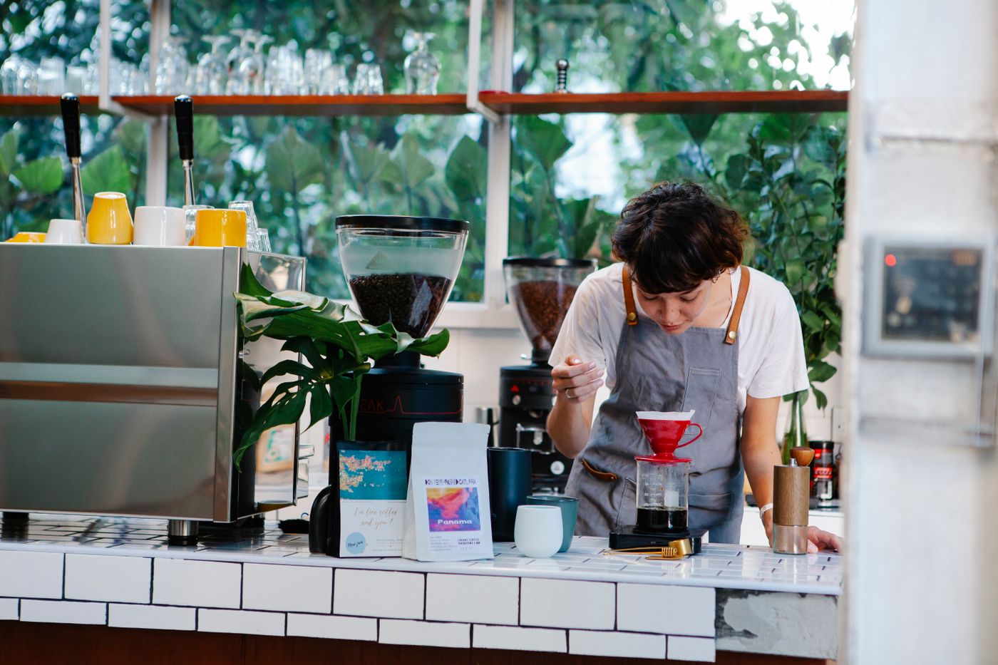 A barista concentrating on a pour-over brew.