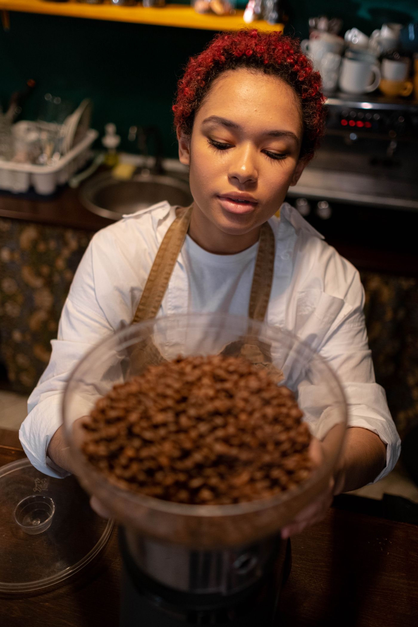 A barista working with coffee equipment.